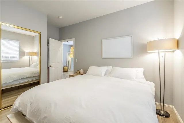 a bedroom with a bed and a lamp