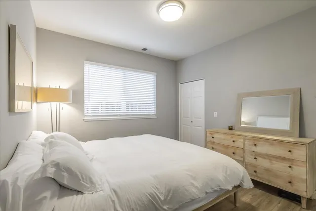 a bedroom with a bed and a dresser