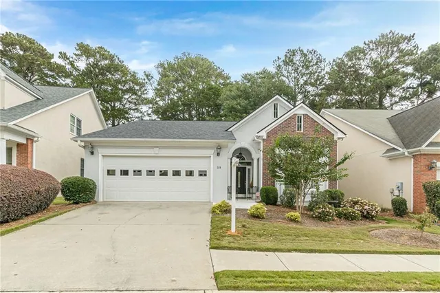 a front view of a house with garden