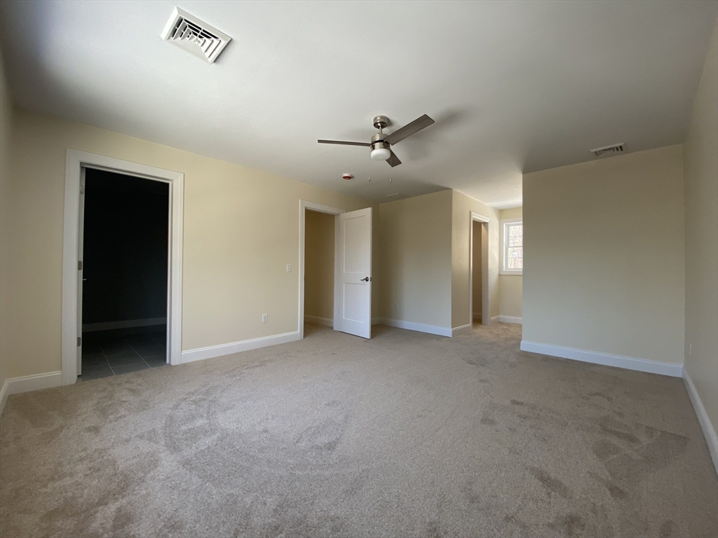 855 County Street, Unit 2 Attleboro, MA 02703 - Photo 22 of 27 a view of a livingroom with a ceiling fan and window