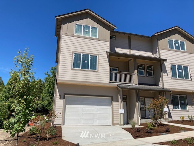 320 South 48th Street, Unit H19 Renton, WA 98055 - Photo 1 of 29 a front view of a house with a yard