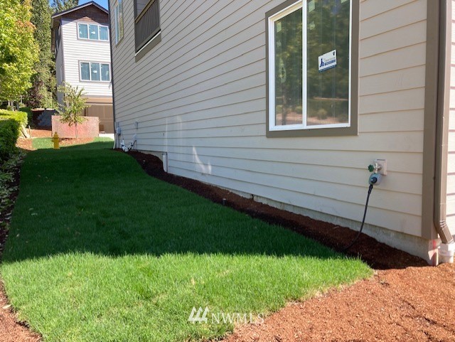 320 South 48th Street, Unit H19 Renton, WA 98055 - Photo 2 of 29 a view of a backyard with plants and large trees