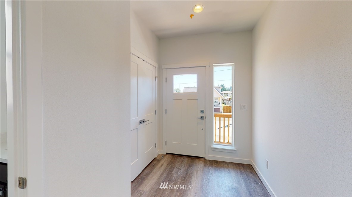 320 South 48th Street, Unit H19 Renton, WA 98055 - Photo 12 of 29 an empty room with wooden floor and windows
