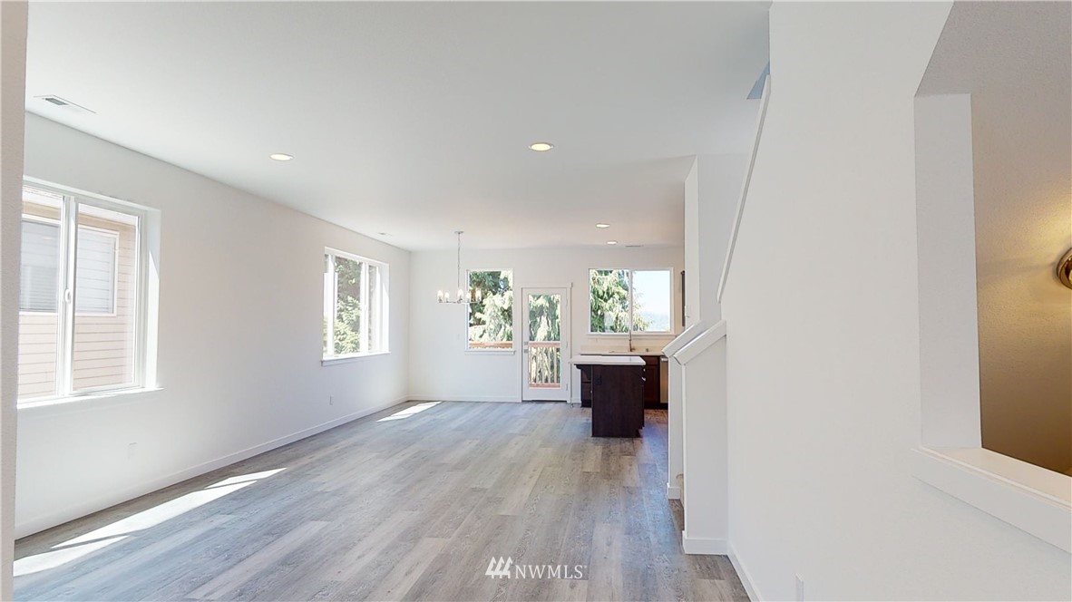 320 South 48th Street, Unit H19 Renton, WA 98055 - Photo 13 of 29 a view of an empty room with wooden floor and a window