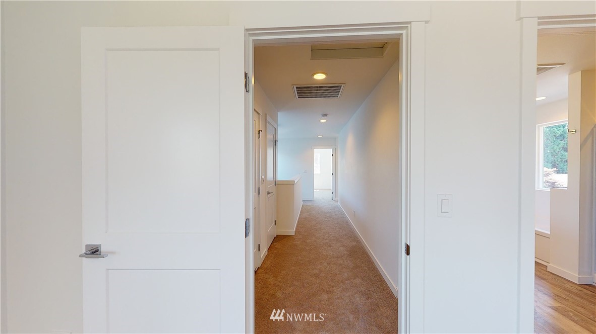 320 South 48th Street, Unit H19 Renton, WA 98055 - Photo 20 of 29 a view of a hallway with a wooden floor