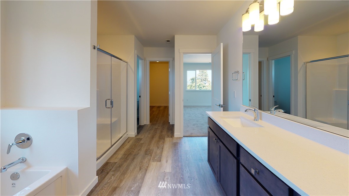 320 South 48th Street, Unit H19 Renton, WA 98055 - Photo 26 of 29 a bathroom with a sink a mirror and a bathtub