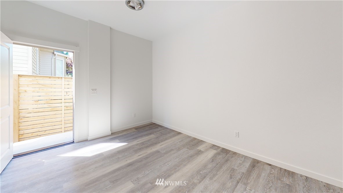 320 South 48th Street, Unit H19 Renton, WA 98055 - Photo 29 of 29 a view of an empty room with wooden floor and a window