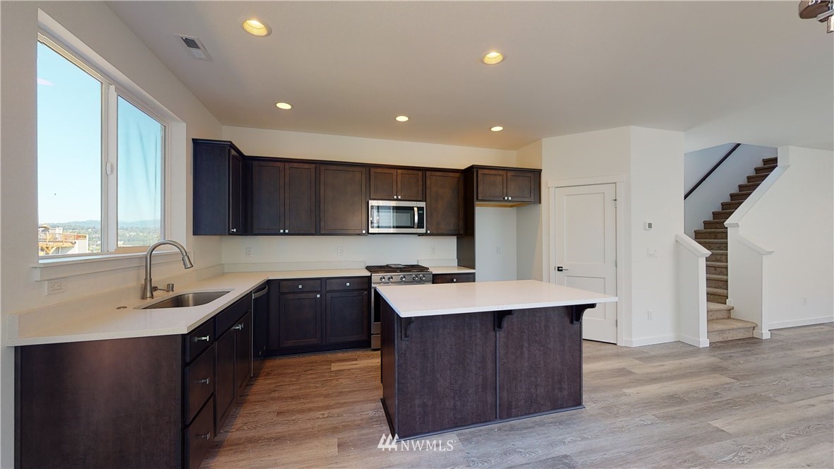 320 South 48th Street, Unit H19 Renton, WA 98055 - Photo 4 of 29 a kitchen with a sink a stove a refrigerator and a oven