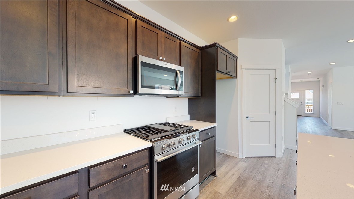 320 South 48th Street, Unit H19 Renton, WA 98055 - Photo 5 of 29 a kitchen with stainless steel appliances a stove microwave and sink