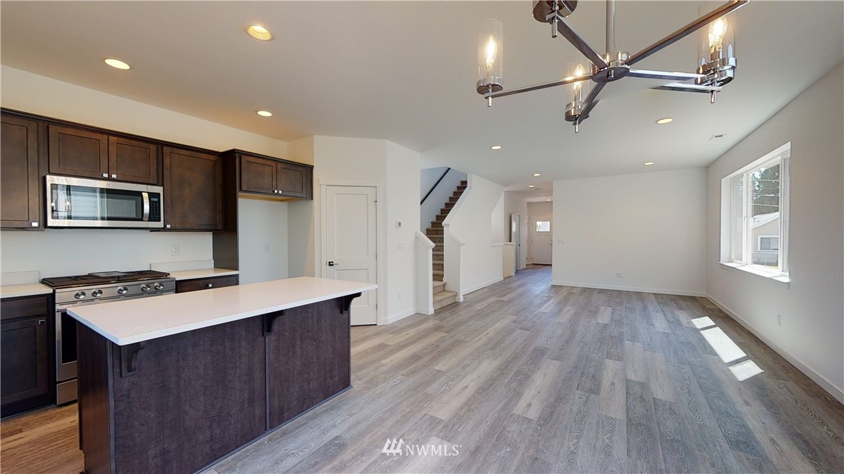 320 South 48th Street, Unit H19 Renton, WA 98055 - Photo 8 of 29 a kitchen with a wooden floor a refrigerator and a sink