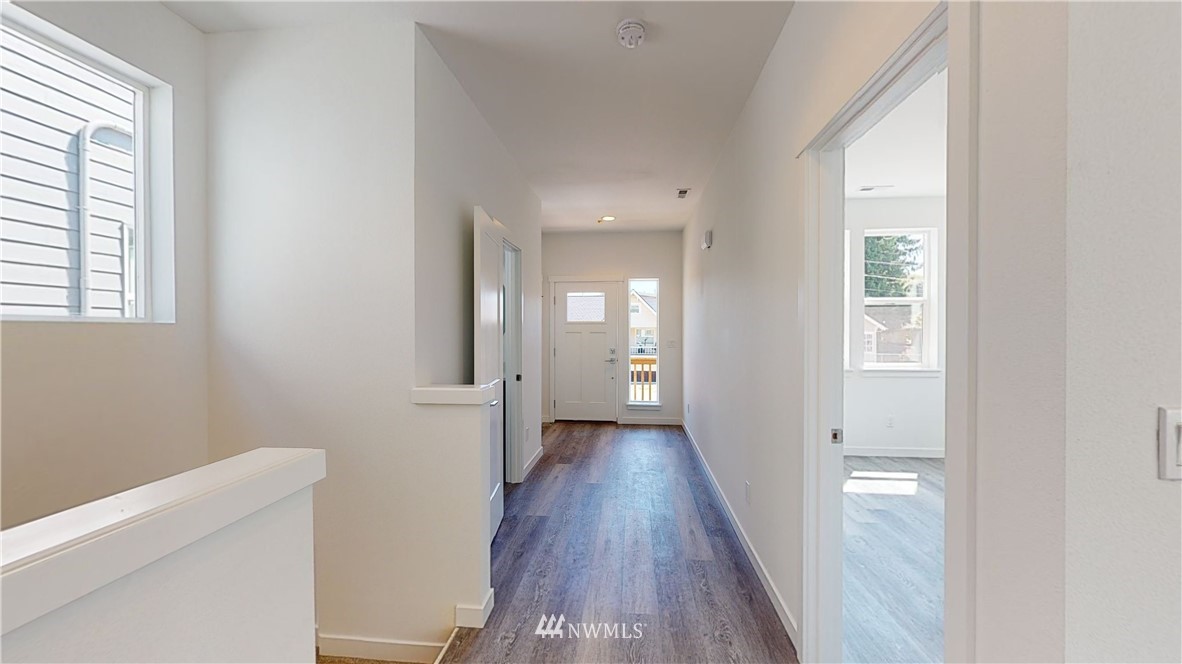 320 South 48th Street, Unit H19 Renton, WA 98055 - Photo 10 of 29 a view of a hallway with wooden floor and a bathroom