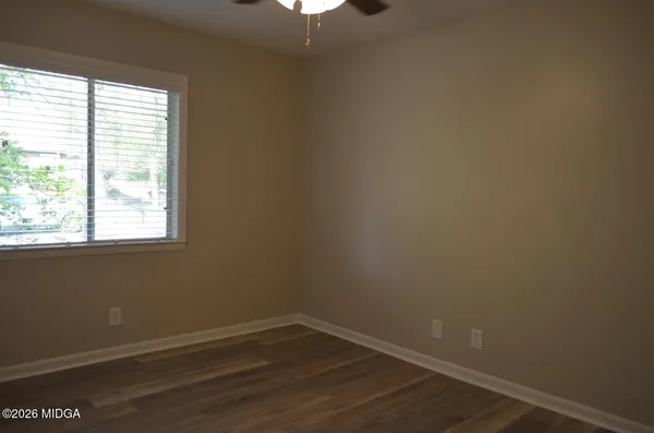 a bathroom with a shower a toilet and sink