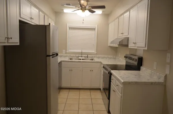 a kitchen with white cabinets