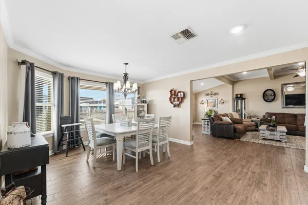 a view of a dining room with furniture window and wooden floor