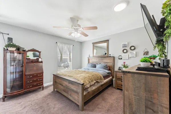 a bedroom with a bed and a chandelier