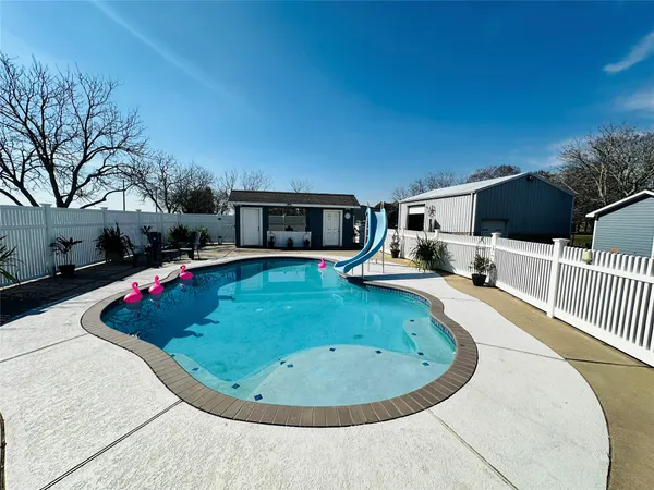 a view of a swimming pool with an outdoor seating