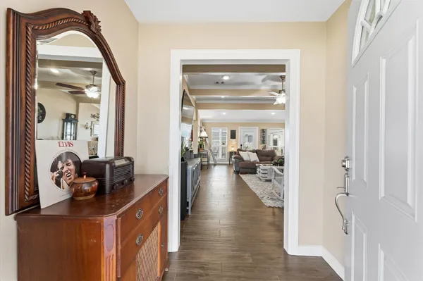 a hallway with a view of living room with furniture