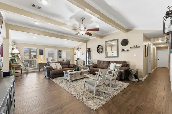 a living room with furniture or wooden floor and chandelier