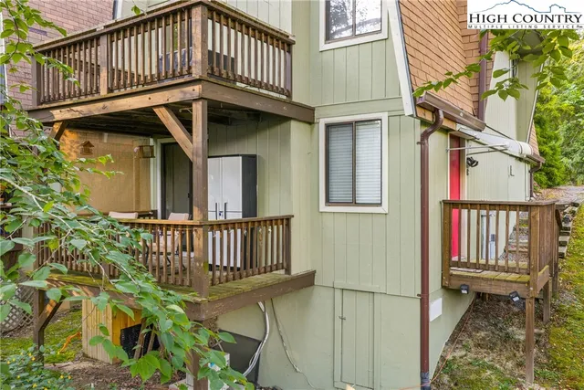 a view of a house with wooden deck