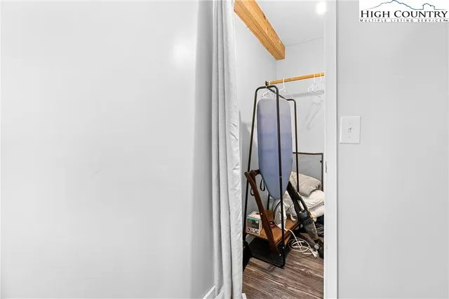 a view of a hallway with wooden cabinets