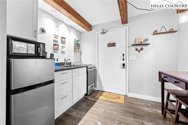 a kitchen with stainless steel appliances a refrigerator and a stove top oven