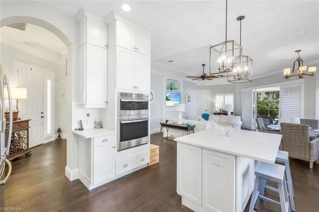 a kitchen with stainless steel appliances a white stove top oven and cabinets