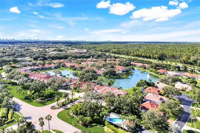 an aerial view of lake and residential houses with outdoor space