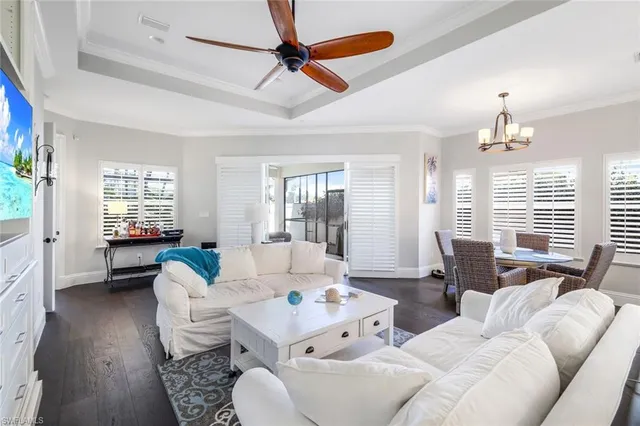 a living room with furniture fireplace and a large window