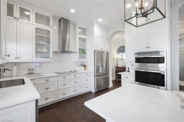 a kitchen with stainless steel appliances a refrigerator sink and cabinets