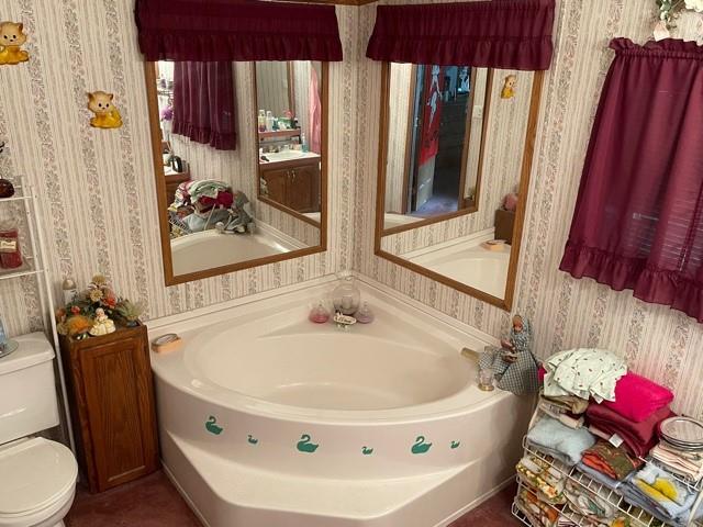 261 St John Road Slippery Rock, PA 16057 - Photo 3 of 18 a bath tub sitting next to a white sink and a mirror