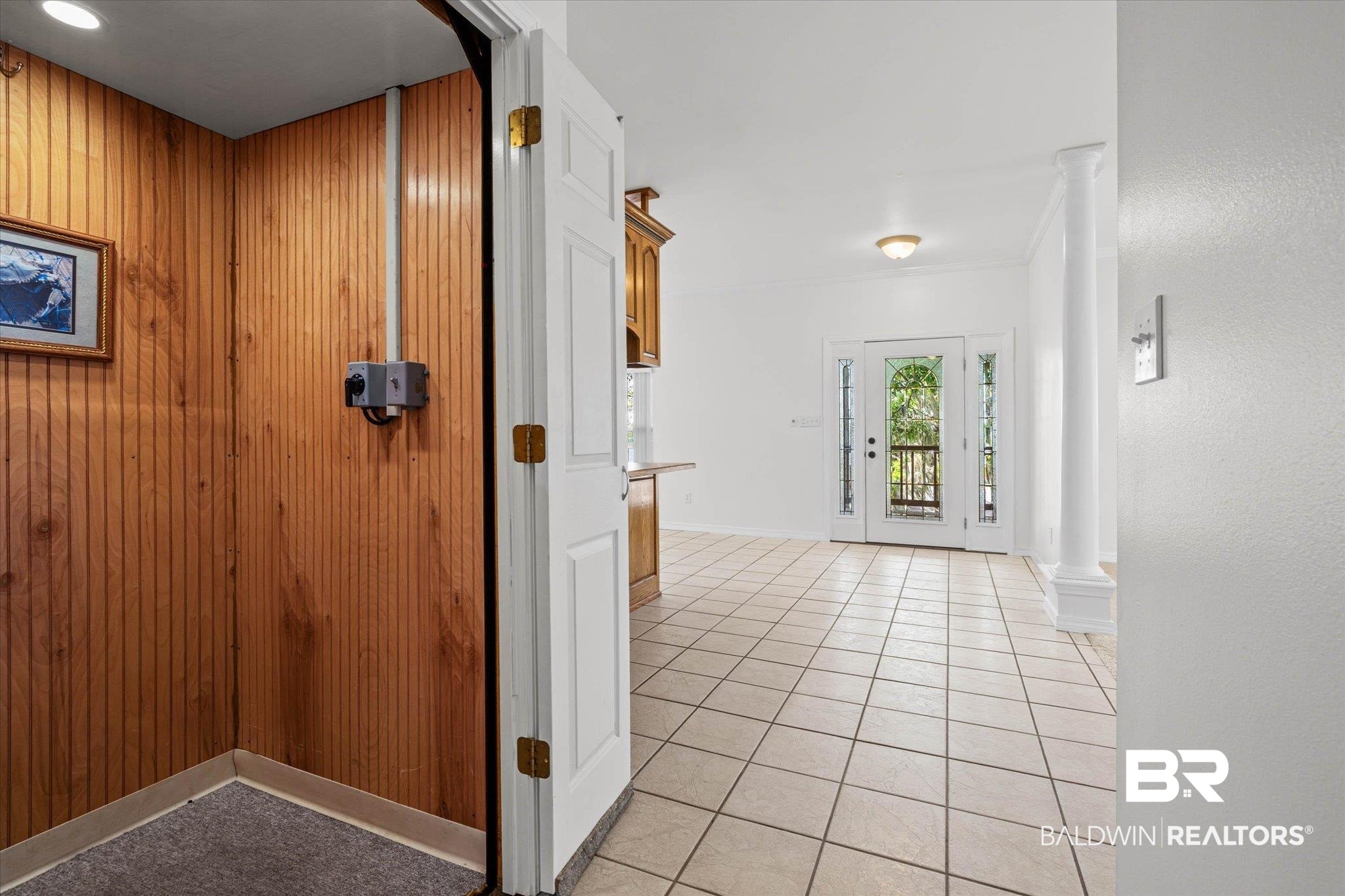 41923 Bayou Road Bay Minette, AL 36507 - Photo 6 of 35 Entryway featuring wood paneling, an overhead light fixture, and a neutral-toned carpeted floor