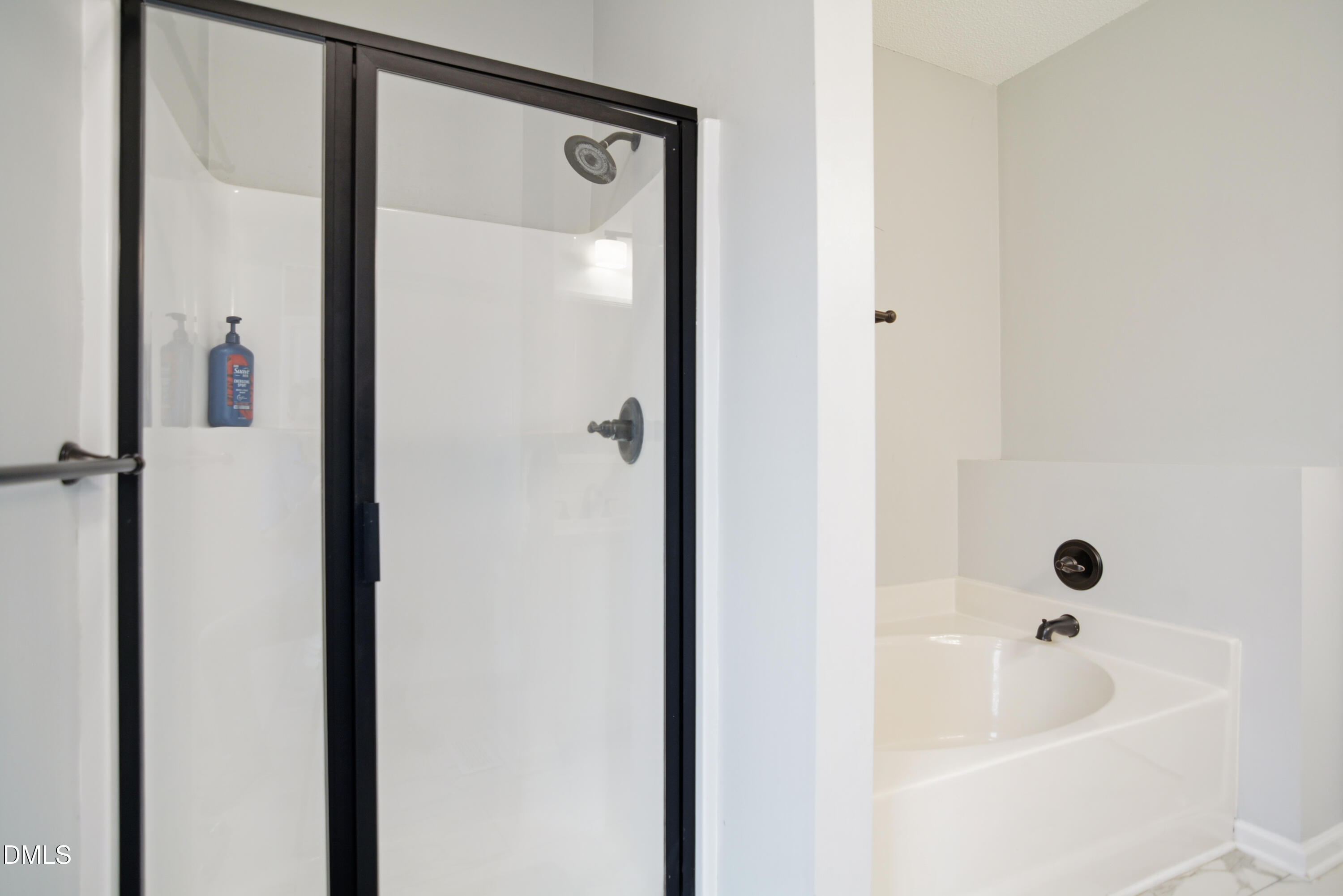4801 Topstone Road Raleigh, NC 27603 - Photo 15 of 29 a bathroom with a tub shower and sink