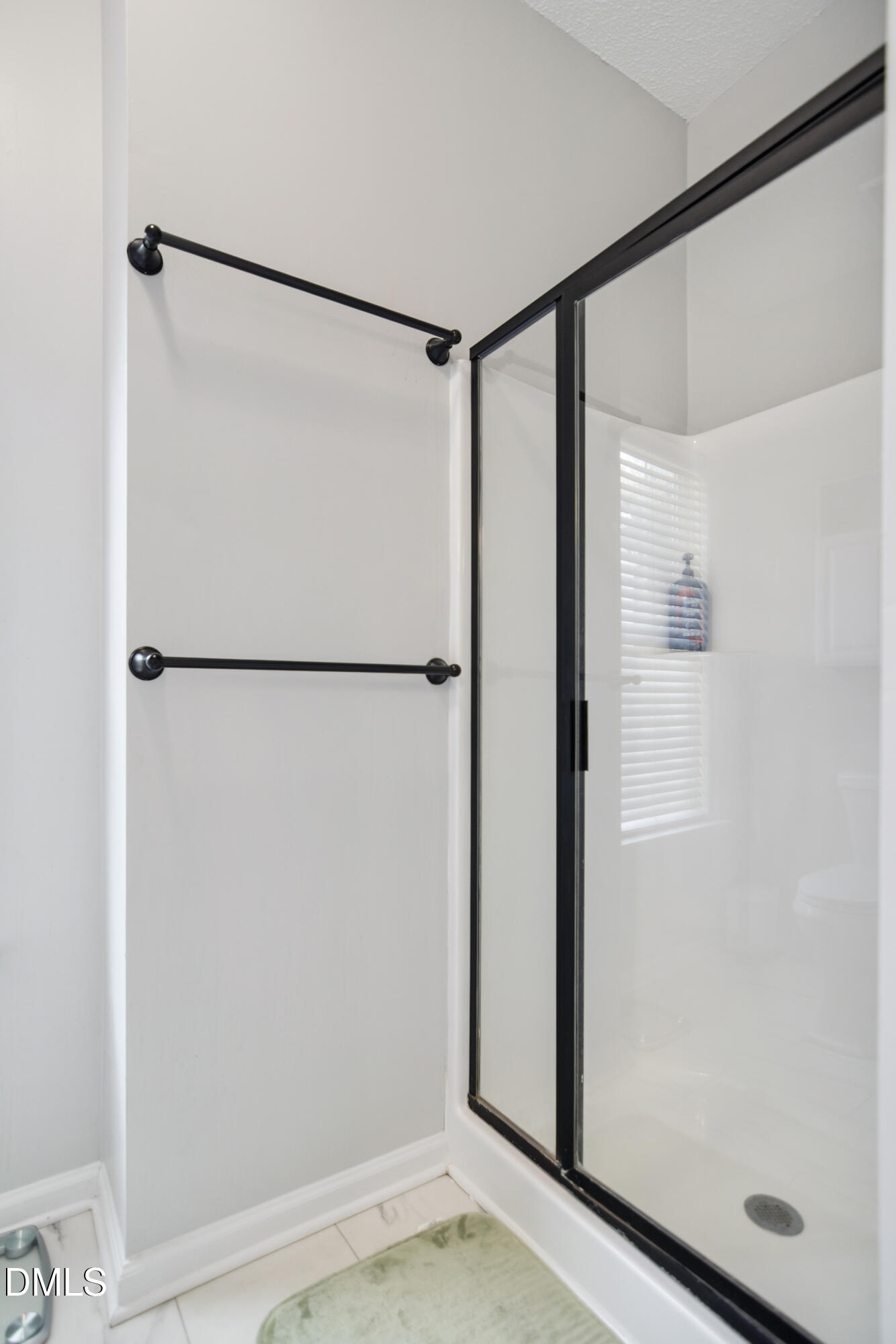 4801 Topstone Road Raleigh, NC 27603 - Photo 16 of 29 a bathroom with a glass shower door