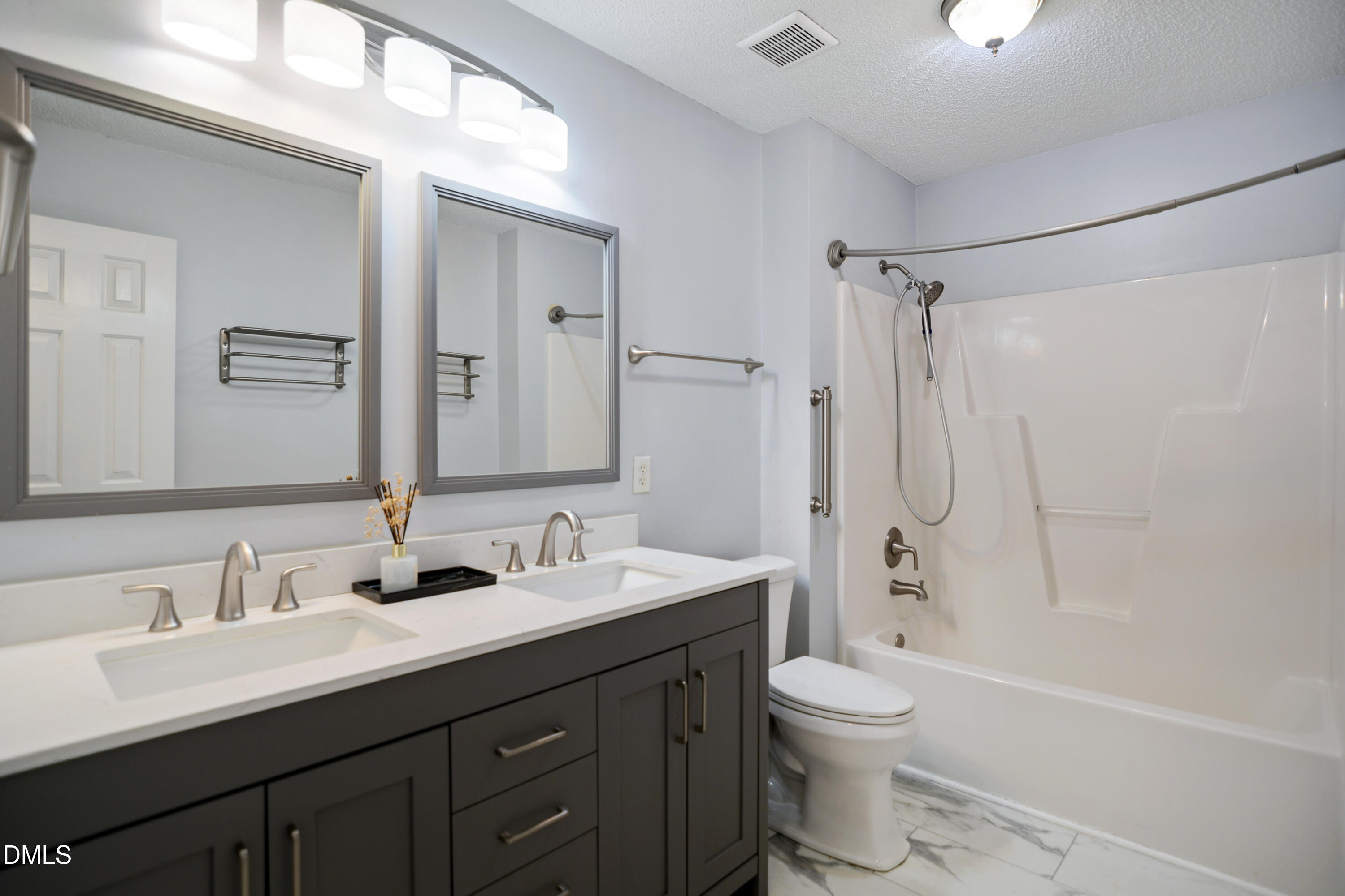4801 Topstone Road Raleigh, NC 27603 - Photo 21 of 29 a bathroom with a double vanity sink toilet mirror and shower