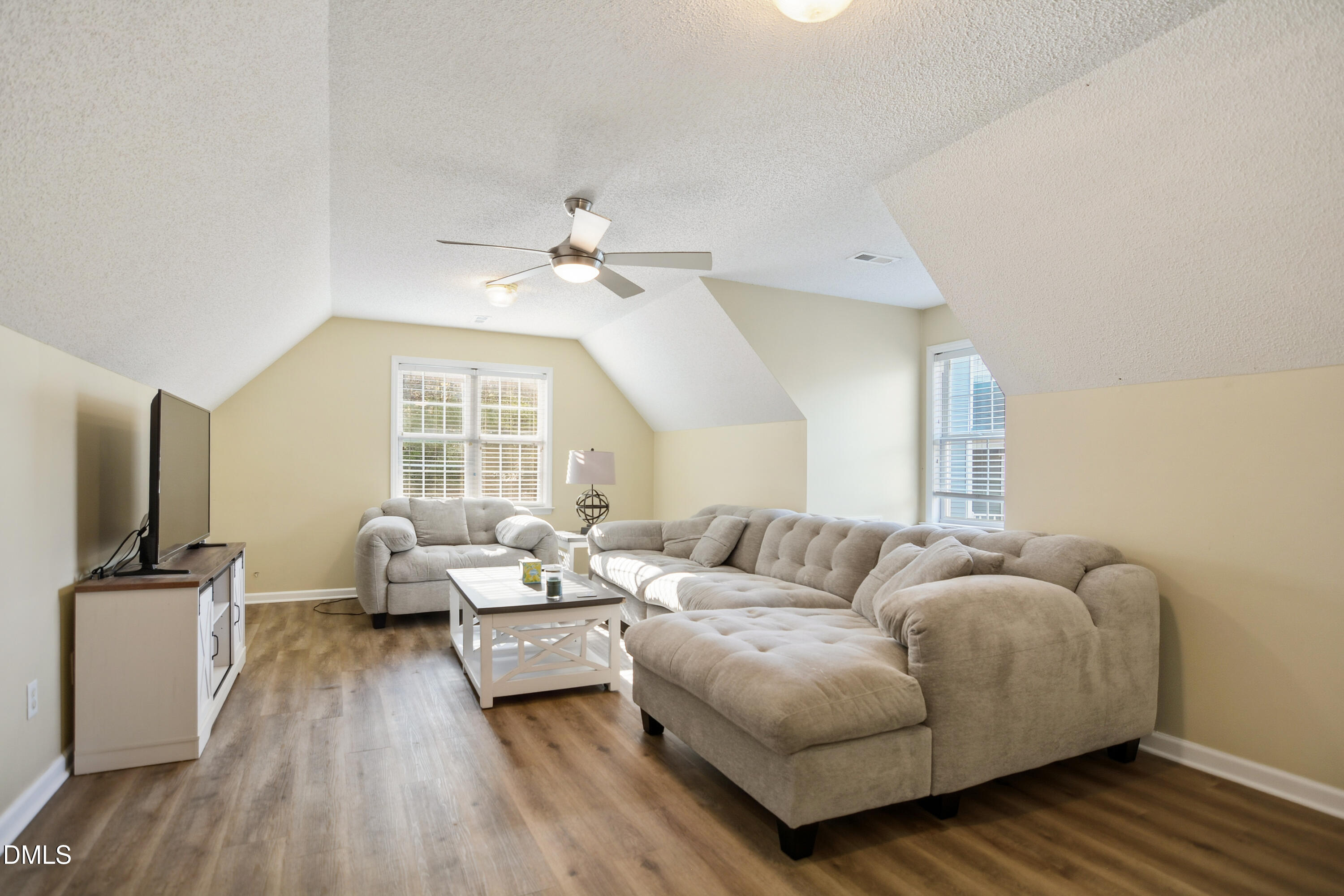 4801 Topstone Road Raleigh, NC 27603 - Photo 24 of 29 a living room with furniture and a flat screen tv