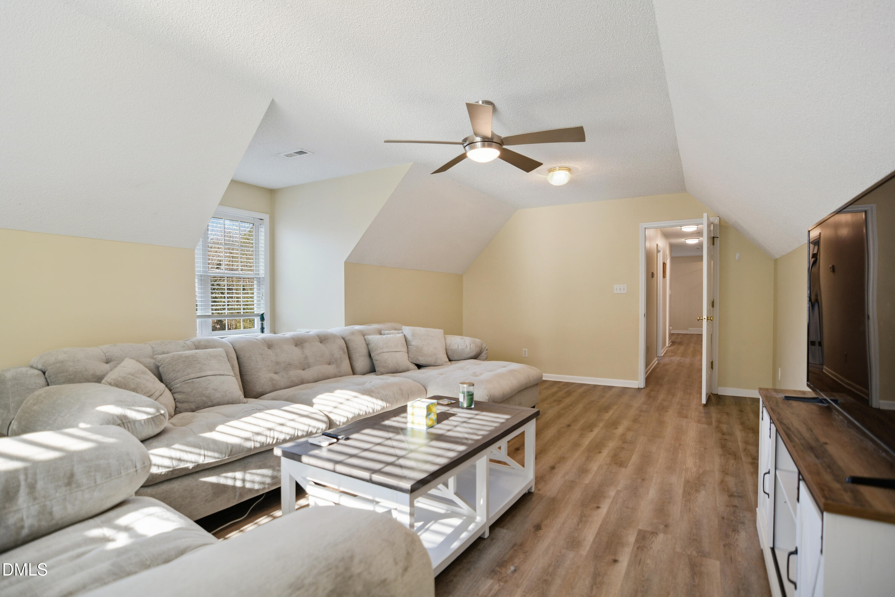4801 Topstone Road Raleigh, NC 27603 - Photo 25 of 29 a living room with furniture and a flat screen tv