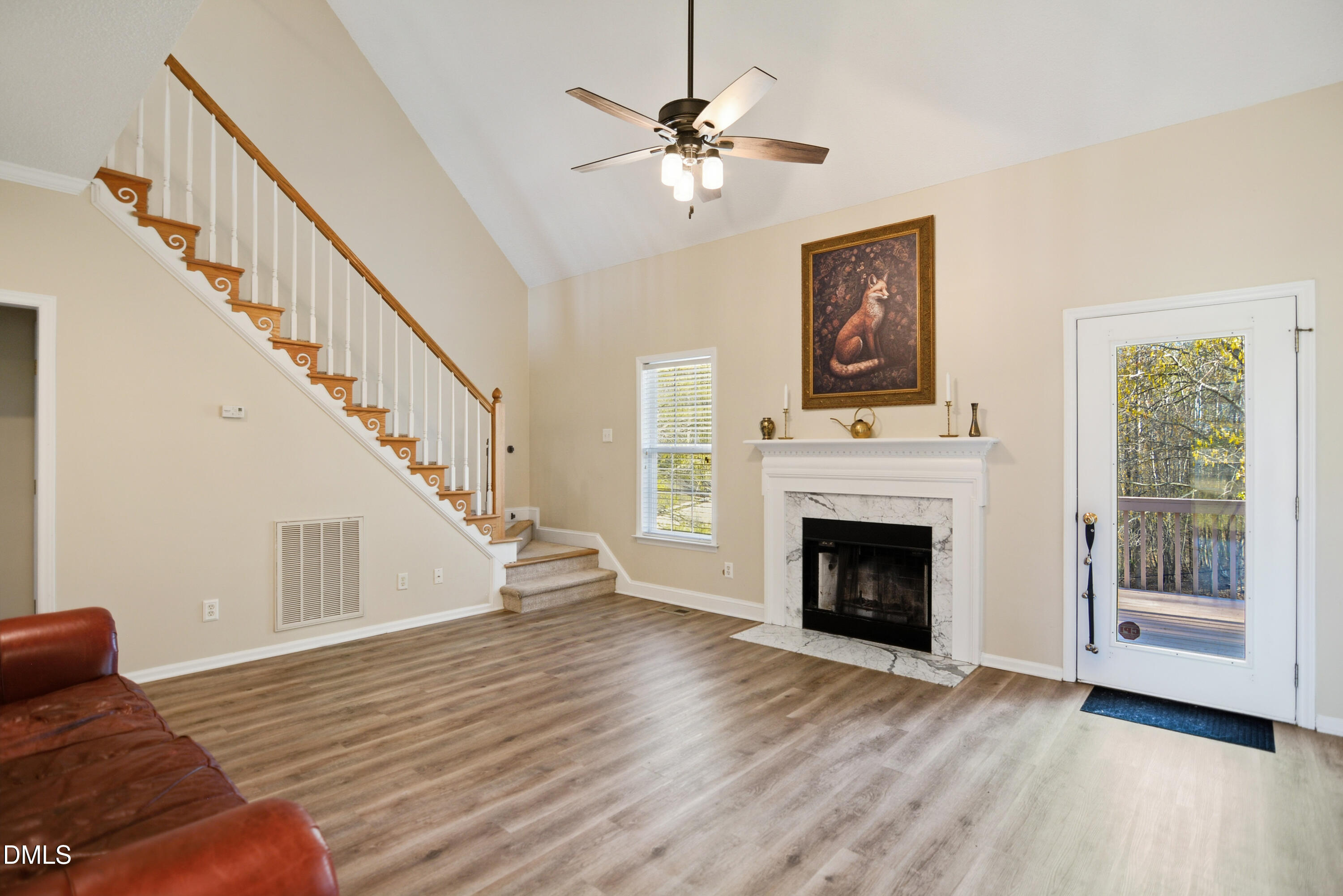 4801 Topstone Road Raleigh, NC 27603 - Photo 3 of 29 a view of an empty room with wooden floor fireplace and a window
