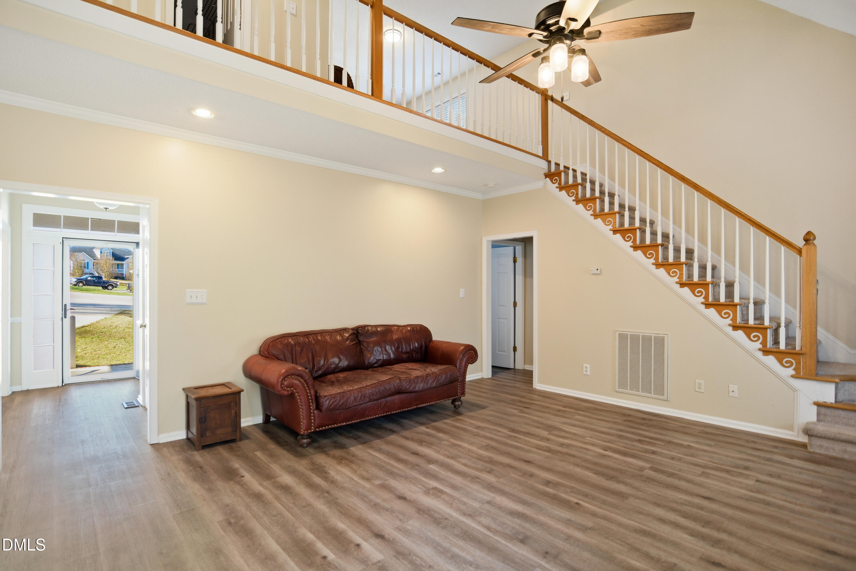 4801 Topstone Road Raleigh, NC 27603 - Photo 5 of 29 a living room with furniture and a stairs