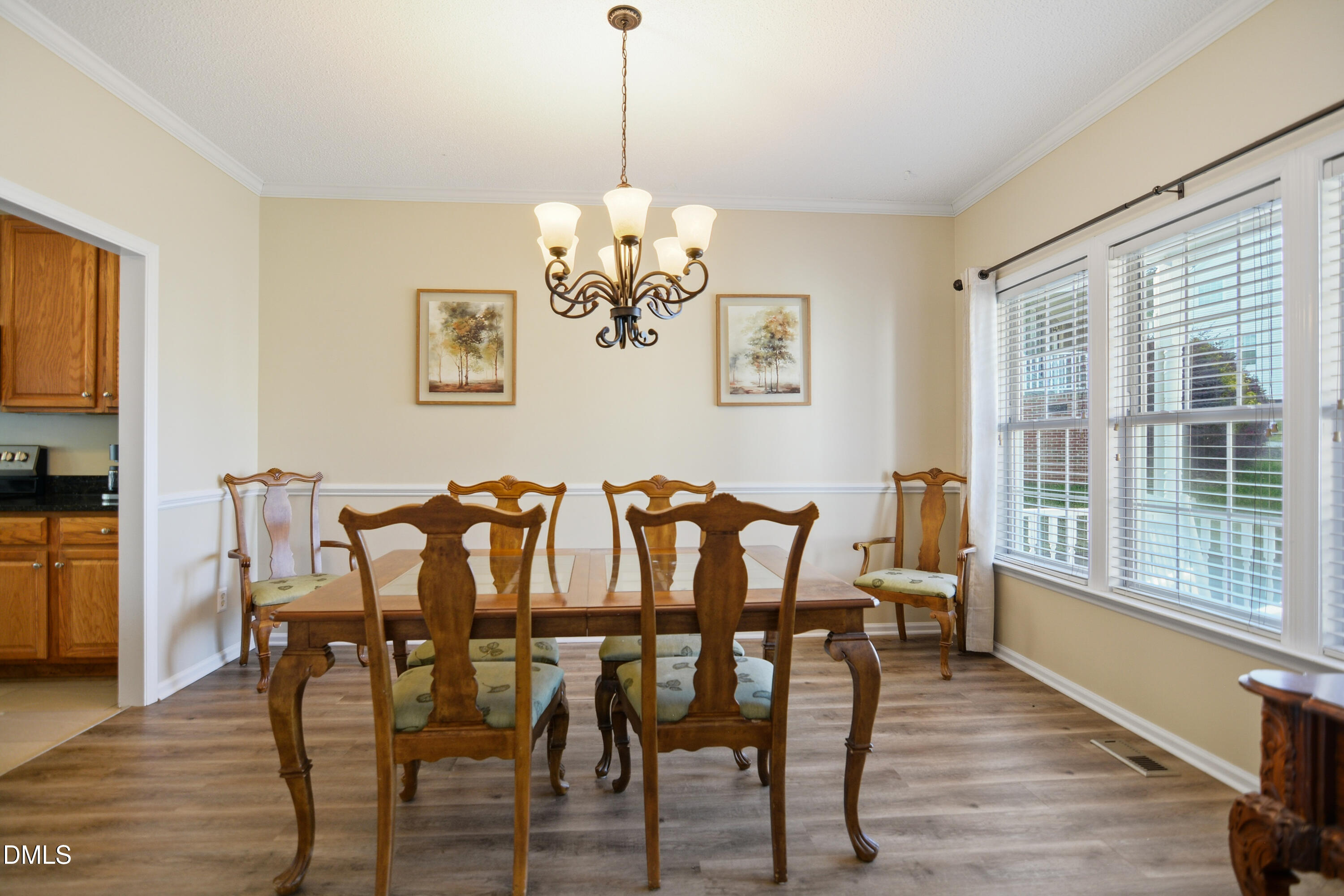 4801 Topstone Road Raleigh, NC 27603 - Photo 6 of 29 a view of a dining room with furniture wooden floor and a chandelier