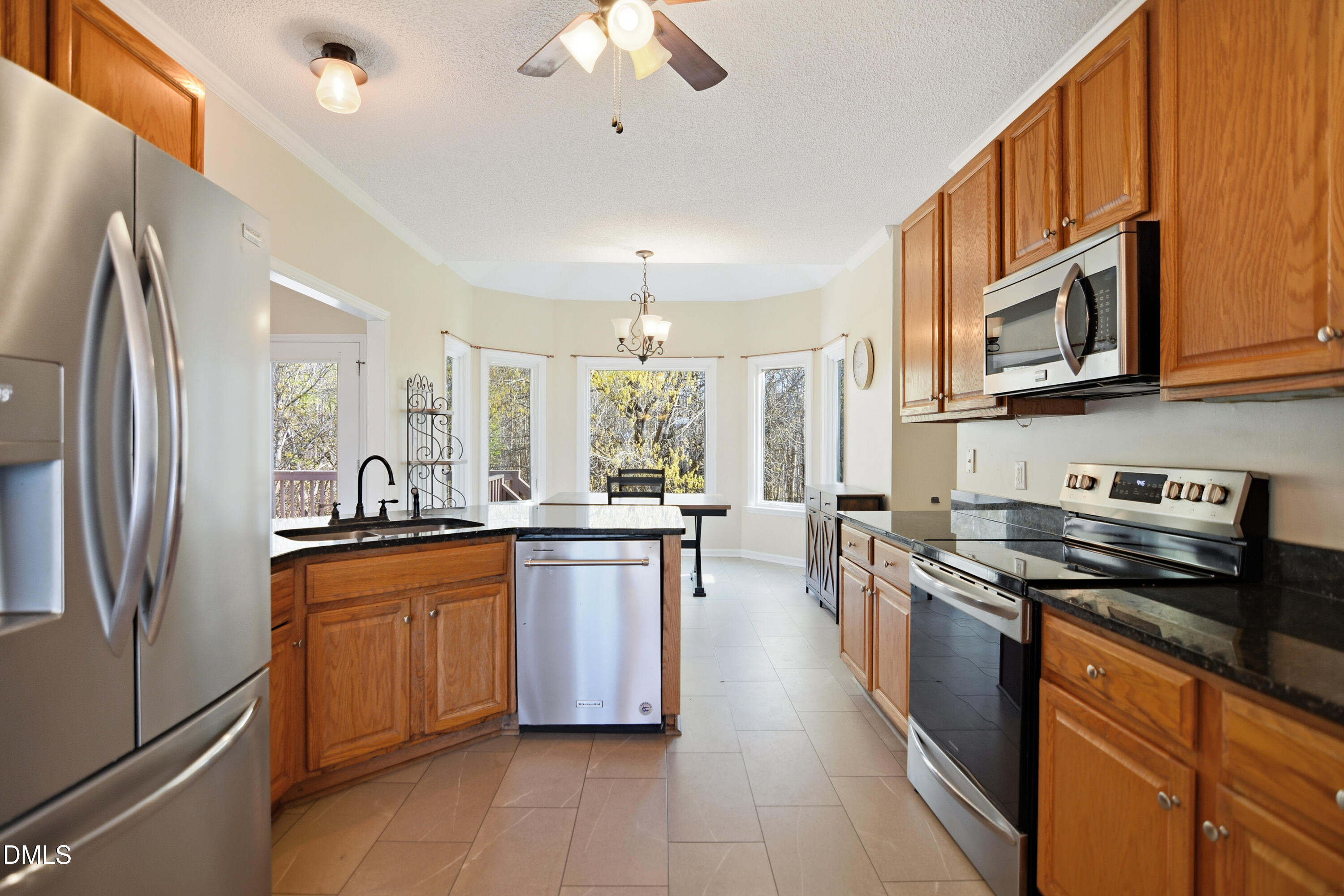 4801 Topstone Road Raleigh, NC 27603 - Photo 9 of 29 a kitchen with stainless steel appliances granite countertop a stove a sink dishwasher a refrigerator and a microwave