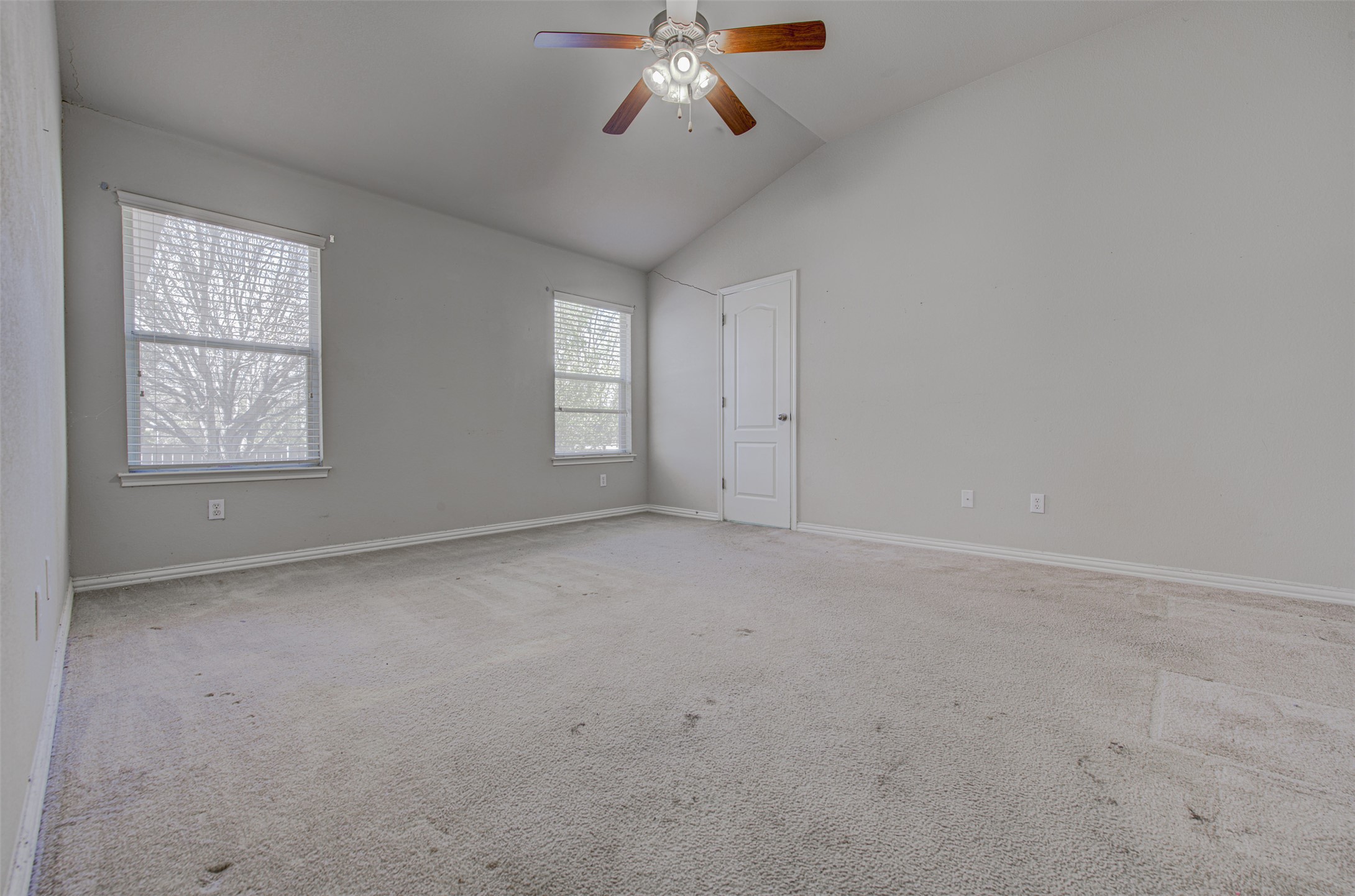 2090 Intrepid Drive Buda, TX 78610 - Photo 11 of 24 Spare room with a ceiling fan, carpet flooring, and vaulted ceiling