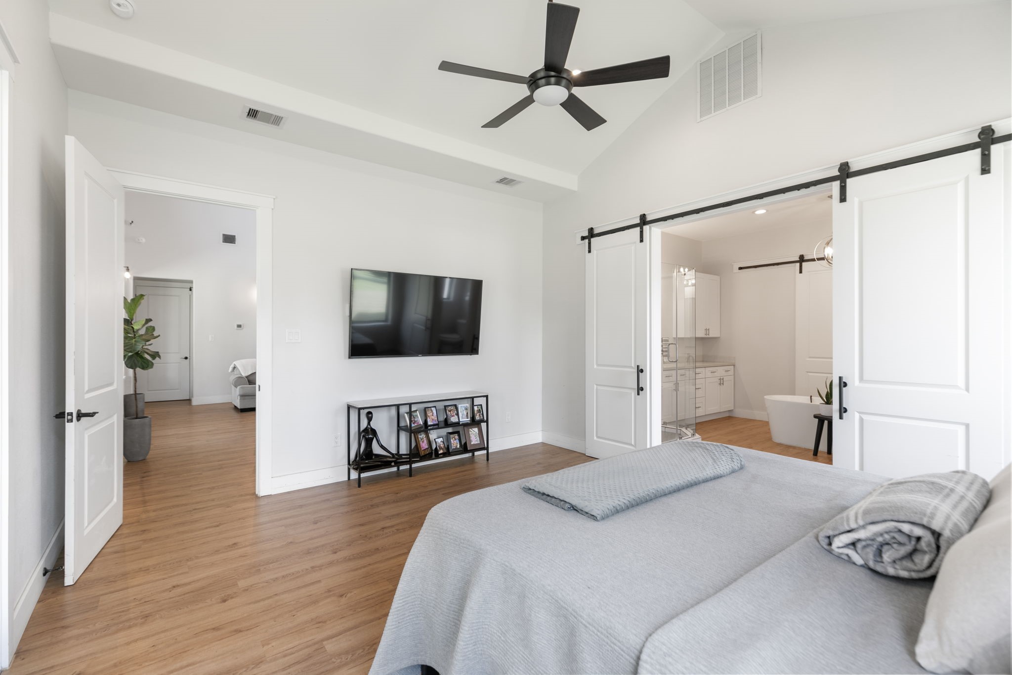 1400 Hicks Street Tomball, TX 77375 - Photo 19 of 45 a bedroom with a bed and a flat screen tv