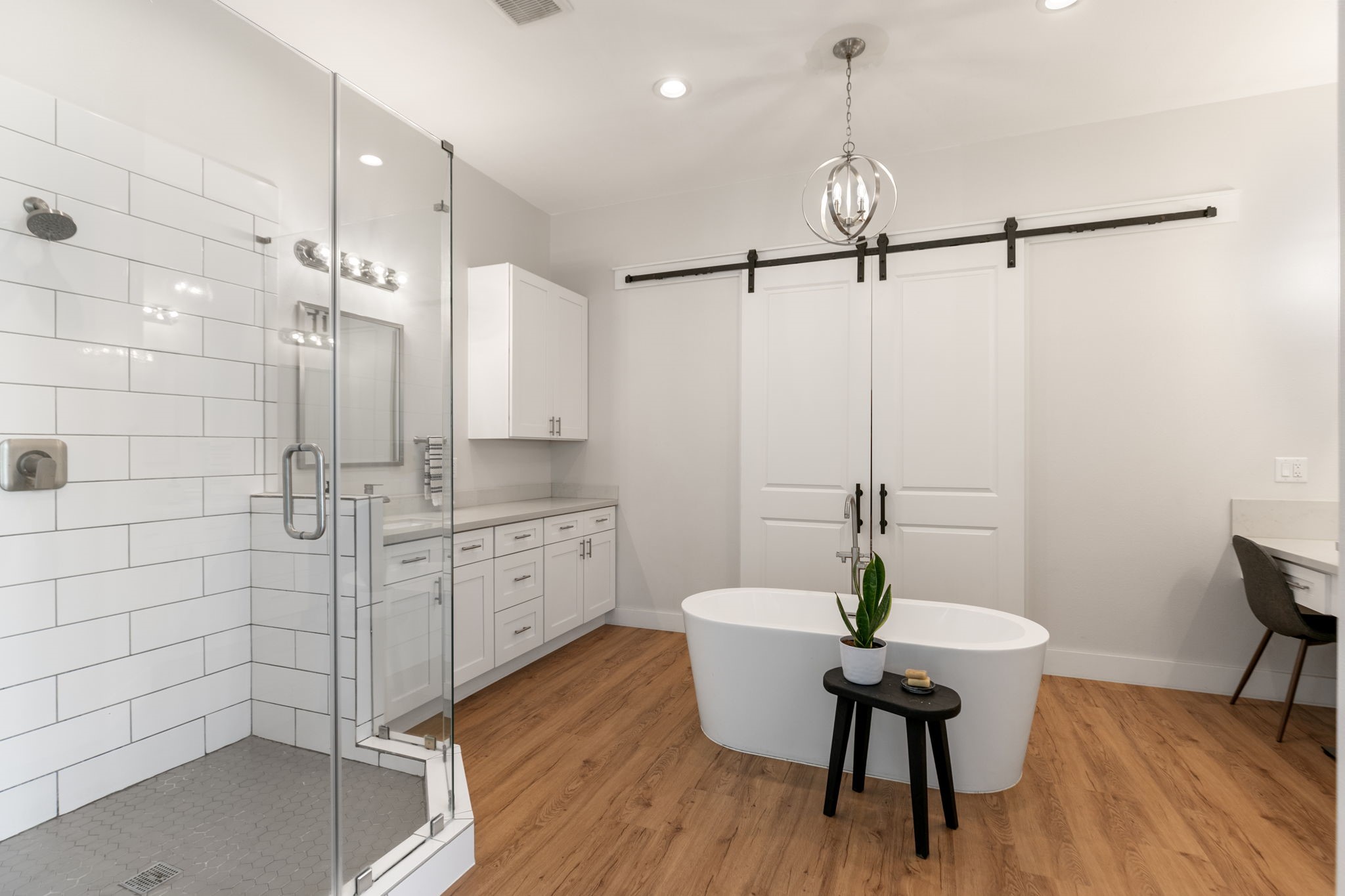 1400 Hicks Street Tomball, TX 77375 - Photo 20 of 45 a bathroom with a sink a mirror a bathtub and a shower