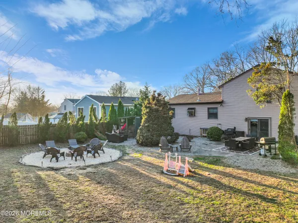 a view of a house with backyard and sitting area