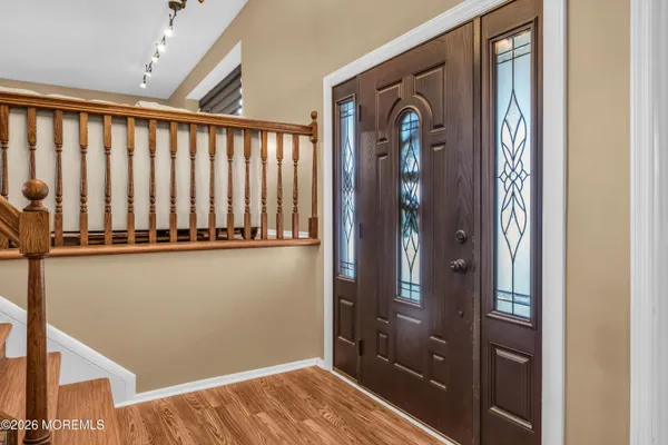 a view of a hallway with wooden floor