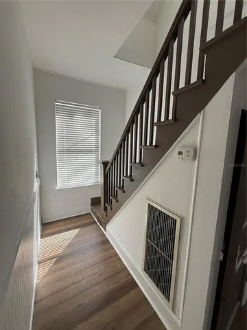 a view of an entryway with wooden floor