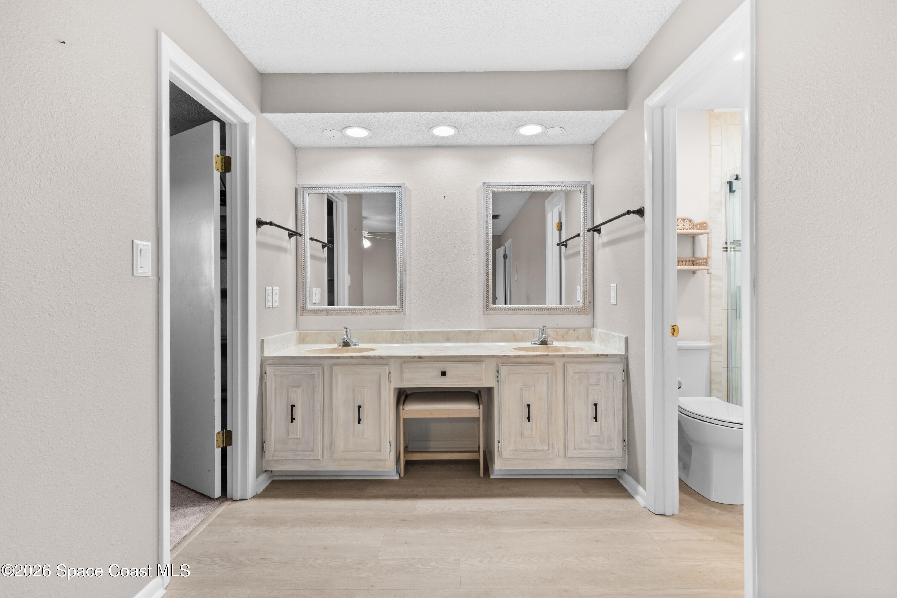 153 Augusta Way Melbourne, FL 32940 - Photo 17 of 38 a spacious bathroom with a granite countertop sink and a mirror