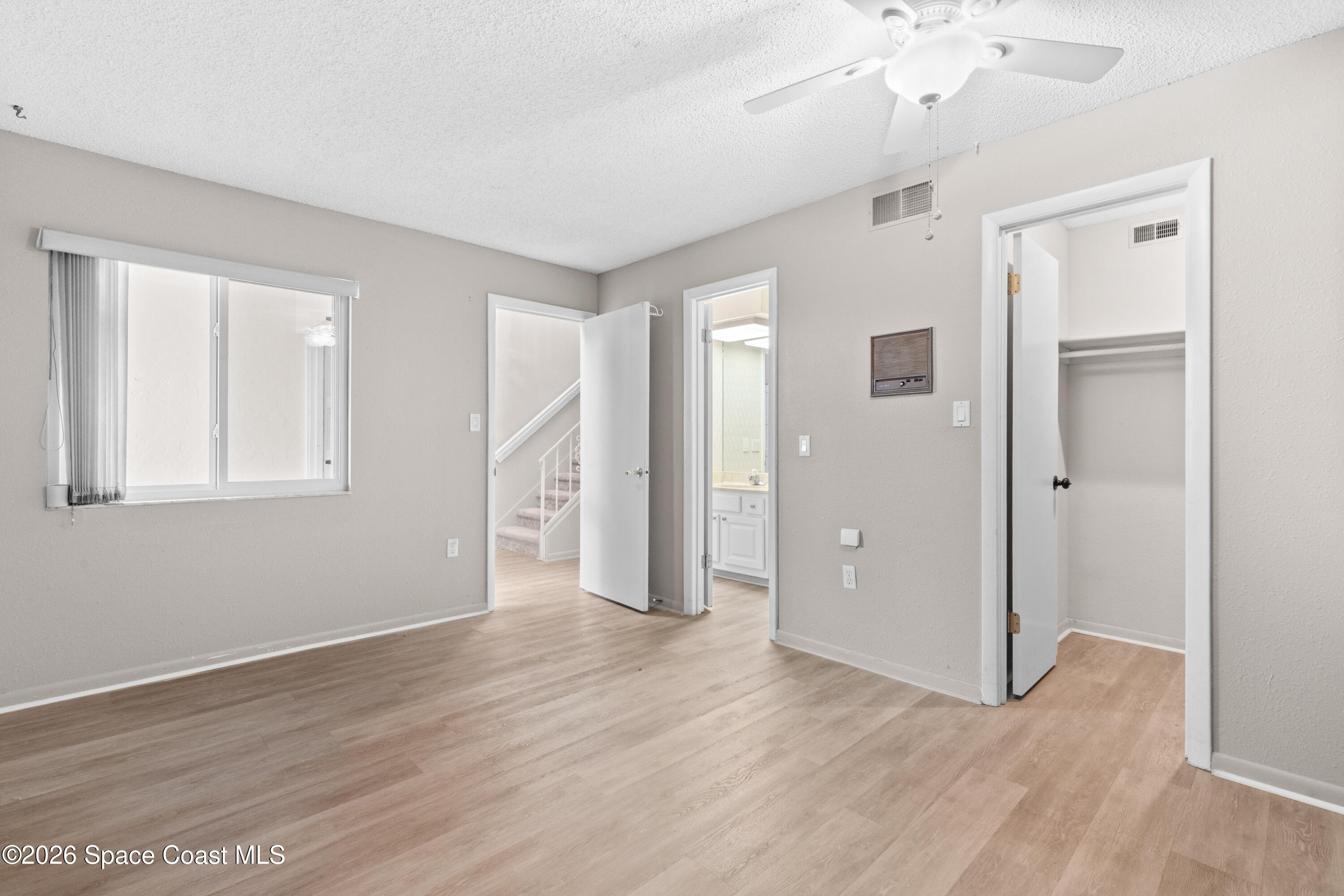 153 Augusta Way Melbourne, FL 32940 - Photo 5 of 38 a view of an empty room with wooden floor
