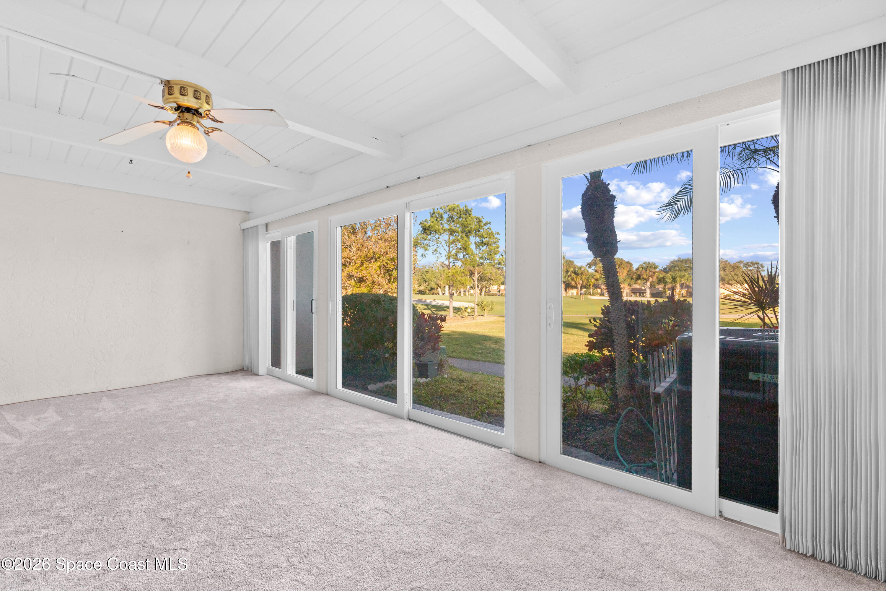 153 Augusta Way Melbourne, FL 32940 - Photo 10 of 38 a view of an empty room with glass door