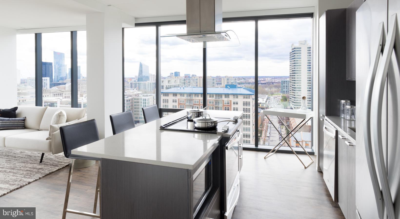 450 North 18th Street, Unit 1B0934 Philadelphia, PA 19130 - Photo 2 of 44 a view of a living room with furniture and floor to ceiling windows